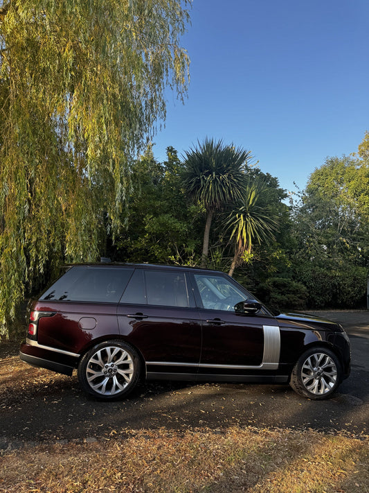 Clean side profile of a dark Range Rover. No pressure washer.